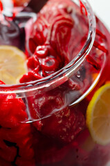 A Halloween bowl with punch, with imitation body parts dipped in red cocktail