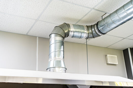Restaurant ventilation system. Galvanized pipes with hoods. Ventilation ducts under ceiling. Air purification in confectionery shop. Ventilation of catering establishments. Restaurant equipment
