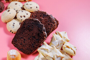 Table with various cookies, pound cake, cake slices, muffins and sweets.
