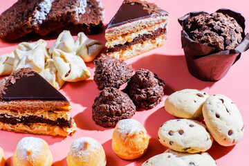 Table with various cookies, pound cake, cake slices, muffins and sweets.