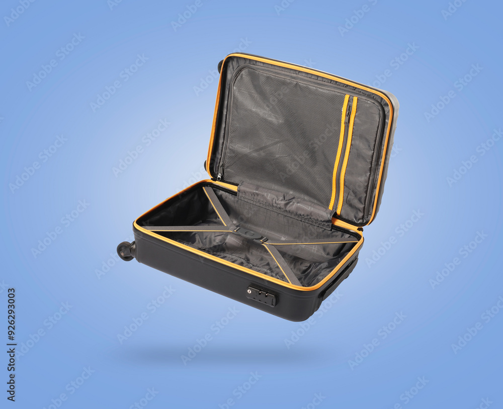 Sticker Open empty suitcase in air on light blue background