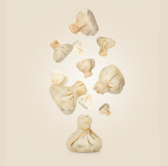 Delicious khinkali (Georgian dumplings) falling on beige background