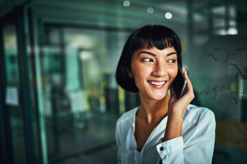 Obraz premium Business, phone call and happy Asian woman in office at night for negotiation, deal or feedback for project deadline. News, mobile and communication specialist listen to contact or client in startup
