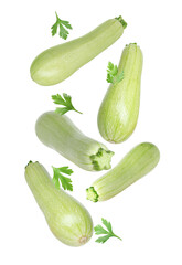 Fresh zucchinis and parsley falling on white background