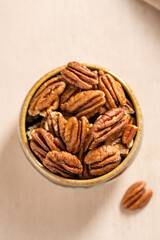  Pecan nuts in a bowl, top view. 