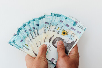 bills of 1000 Ukrainian hryvnias in hands