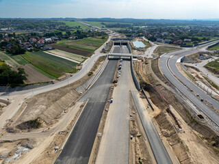 Tunnel and viaduct in Northern part of circular highway bypass around Krakow under construction near Zielonki Junction on S52 aiming to join A4 with S7. State in August 2024. Aerial view