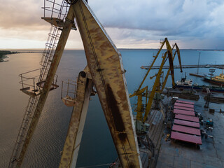 Old Cranes in the cargo port in Kopli at sunset on a summer evening, photo view from a drone.