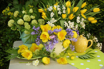 Spring flowers still life arrangement on a table outdoors