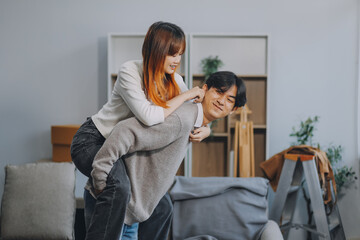 Asian Female discussing new project with male colleague. Young woman talking with young Asian man with financial on sofa in home office