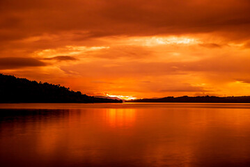 Silhouettes of mountains and sunset on the beach