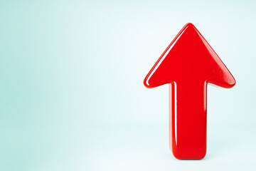 Glossy Red Upward Arrow on Light Blue Background. 3D Rendering