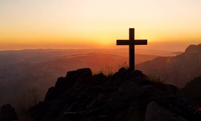 Silhouette of a cross atop a rocky hill against a dramatic sunset, evoking a peaceful and spiritual atmosphere