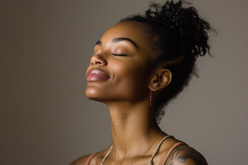A close up of a tattooed black woman's face with her eyes closed