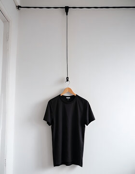 Black T-Shirt Hanging from Ceiling Wire on Hanger Generative AI