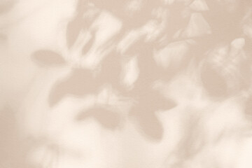 Light and shadow pink beige pastel abstract background. Natural leaves shadows and sunshine...