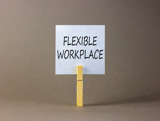 Flexible workplace symbol. Concept words Flexible workplace on beautiful white paper on wooden...