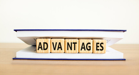 Advantages symbol. Concept word Advantages on beautiful wooden cubes in book. Beautiful wooden...