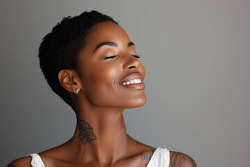 A close up of a tattooed black woman's face with her eyes closed