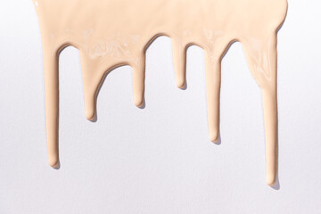 Flow foundation on a white background, art in cosmetics.