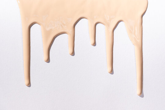 Flow foundation on a white background, art in cosmetics.