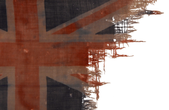 An old and heavily worn section of a British, Union Jack flag from the Royal Navy.