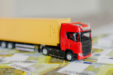 Toy truck on euro banknotes. Logistics, transportation concept.