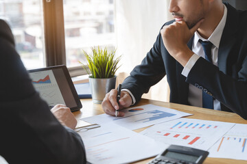 financial advisory services. Asian advisor showing plan of investment to clients in the consultancy office.
