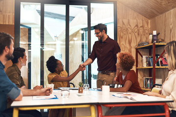 Office, business people and handshake in meeting for welcome, introduction and onboarding with smile. Team, employees and manager of marketing agency with client for shaking hands, deal or thank you