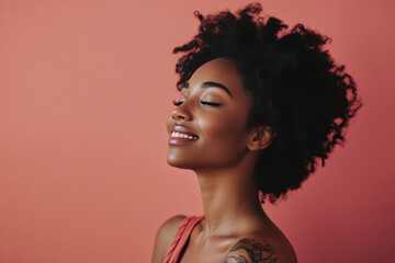 A close up of a tattooed black woman's face with her eyes closed