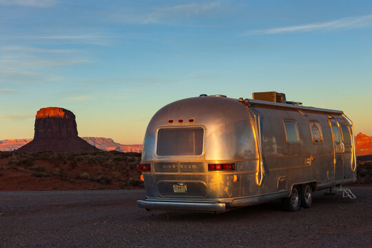 Oljato-Monument Valley, Arizona, USA, October 16, 2014 - Vintage silver Airstream trailer parked in the Monument Valley Navajo Tribal Park, with beautiful red sandstone butte in the background