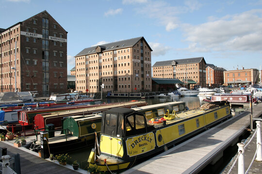 Gloucester quays with narrow boats, commercial and residential properties in the UK