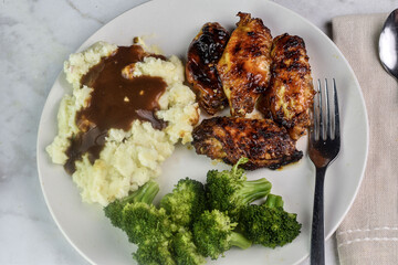 barbecue wings with  mash potatoes and gravy