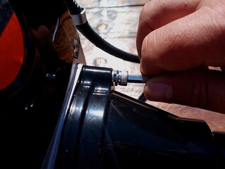Fixation of the metal black gearbox of the brush cutter with the help of bolts and a hex...