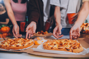 Group of young friends eating pizza.Home party.