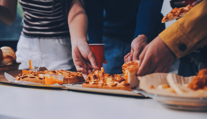 Group of young friends eating pizza.Home party.