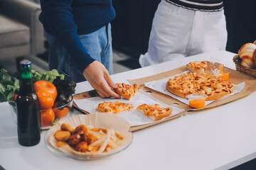 Group of young friends eating pizza.Home party.