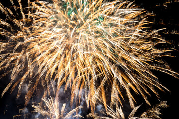 Festive fireworks brighten the night sky. Brilliant fireworks illuminate the dark sky, showcasing vibrant colors and sparkles during a festive event.