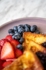 French toast with strawberry, blueberry and blackberry.