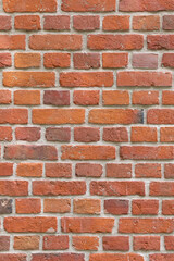 Close-up of a red brick wall. rough, aged bricks. Background and texture