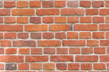 Close-up of a red brick wall. rough, aged bricks. Background and texture