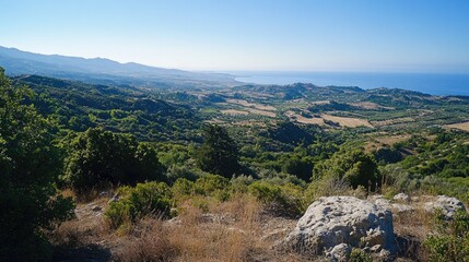 Scenic overlook from Filerimos Hill, gazing southwest towards the expansive coastline and rolling hills below.