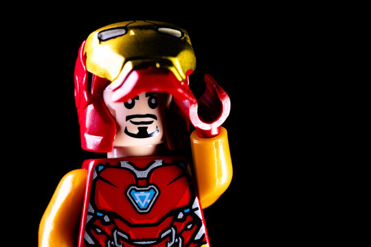 LEGO Marvel's Iron Man Tony Stark lifts up his helmet mask. Toy Iron Man removes his mask