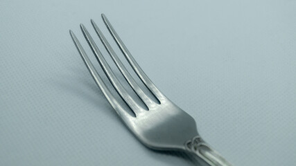 Iron fork close-up on a white background. Silver fork on a white background