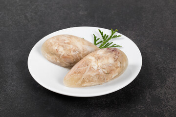 Cold appetizer. Chicken jellied meat in the shape of a quenelle. Dark gray background