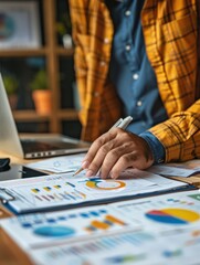 Fototapeta premium Business Professional Analyzing Financial Reports and Data Charts in a Modern Office Setting