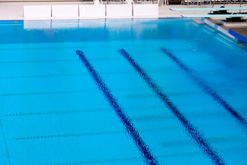 empty blue swimming pool for swimming and competitions inside