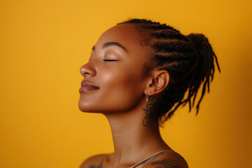A close up of a tattooed black woman's face with her eyes closed