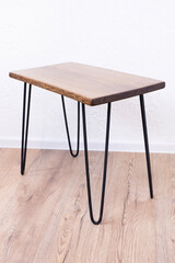 Wooden table in loft style. Parts of an oak table with iron legs. In the room