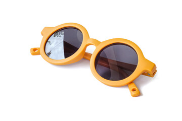 Yellow kids sunglasses close up on white background.